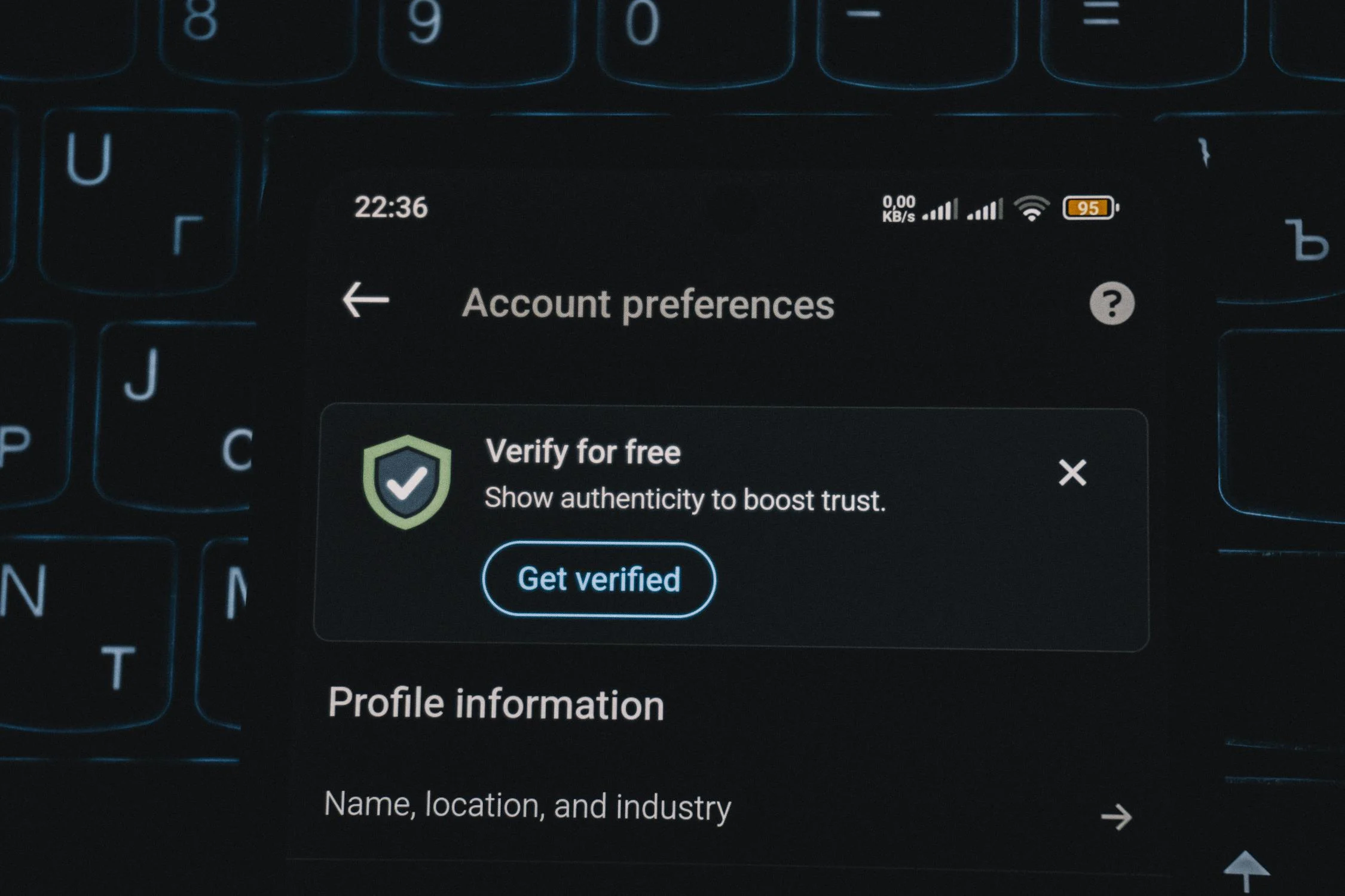 A phone showing an account verification alert, simulating a 3D Secure or secondary verification step during online payment