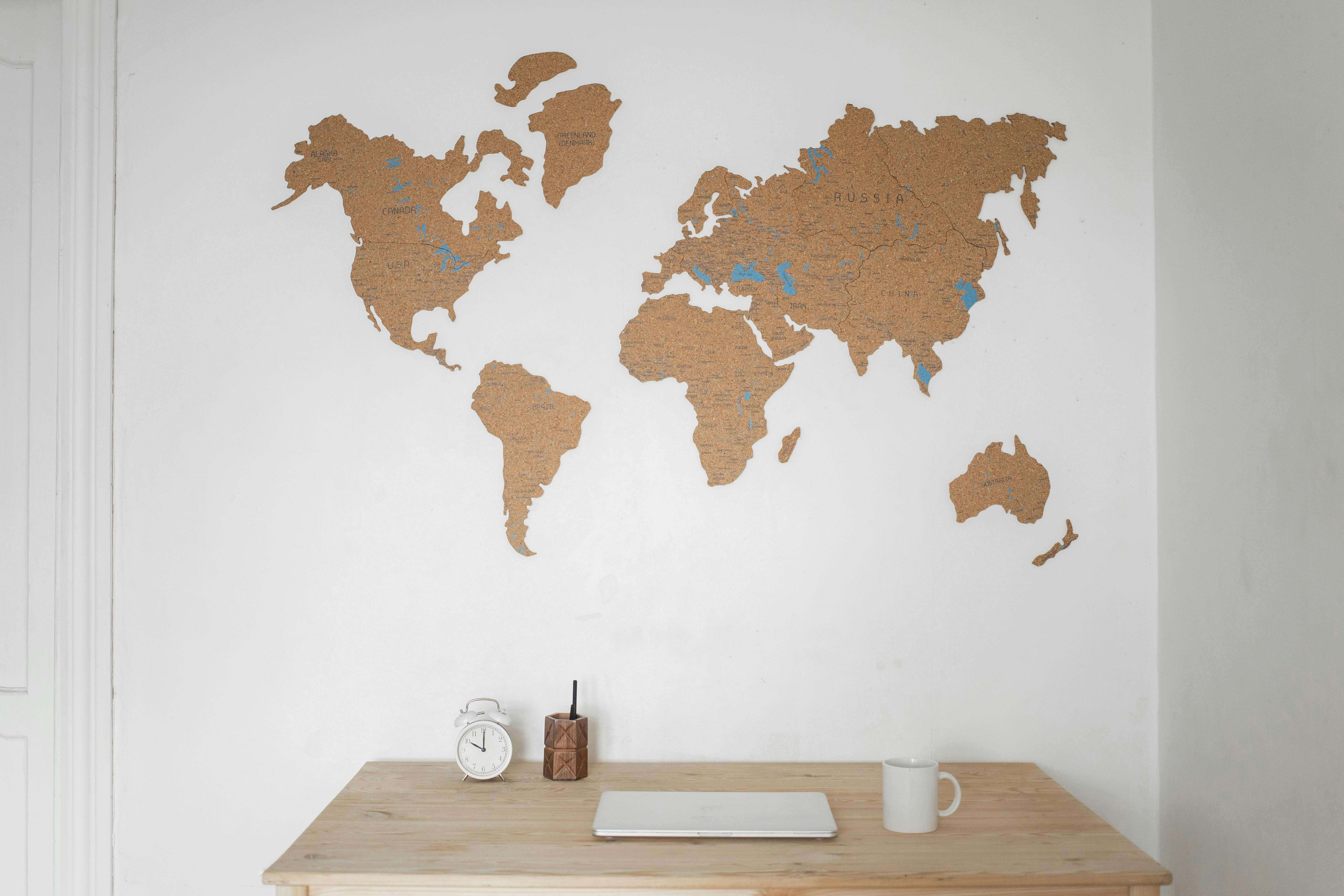 User evaluating whether overseas asset allocation fits their income and lifestyle needs with a laptop and world map