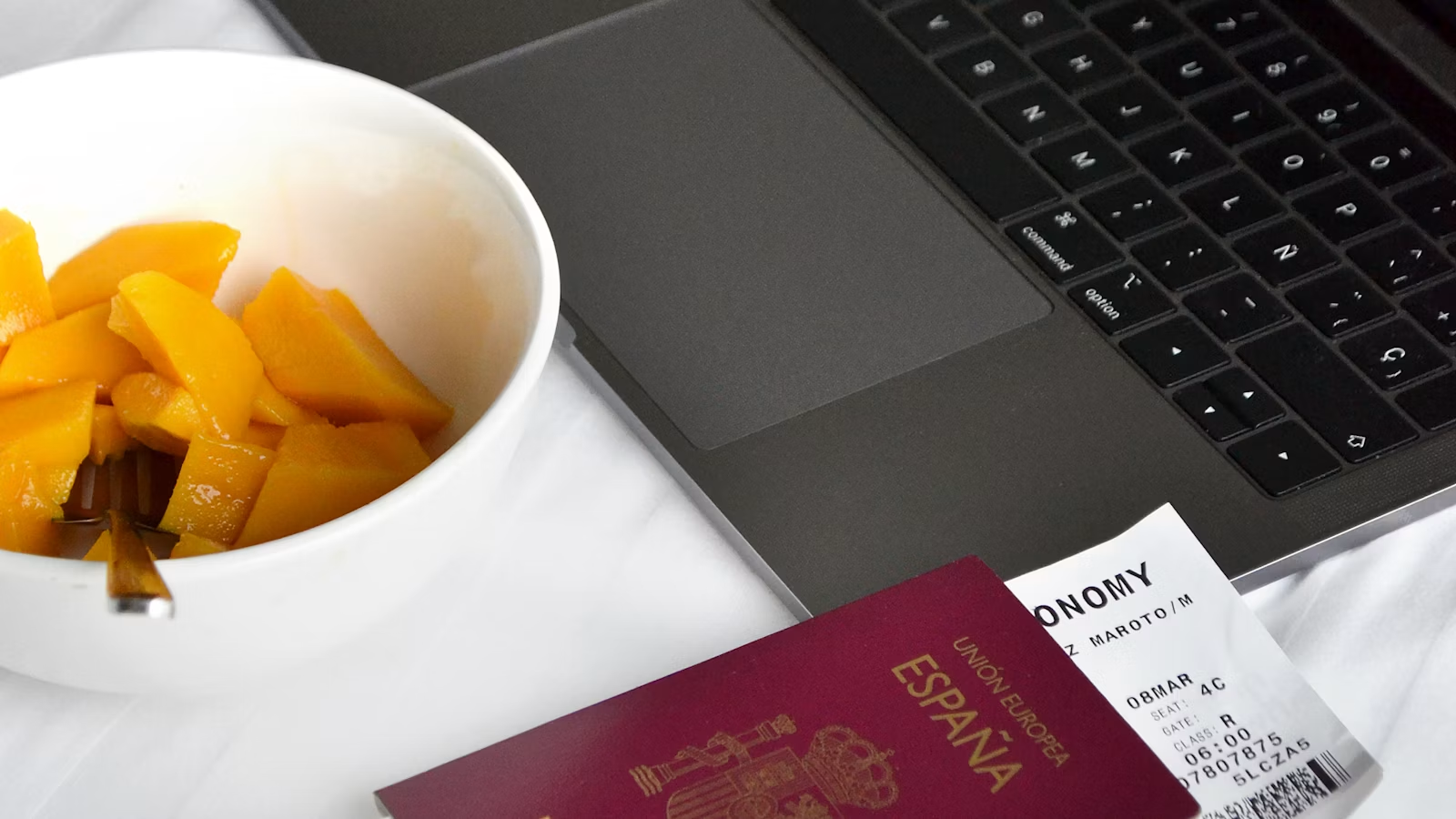 Passport, travel documents, and laptop for overseas account preparation