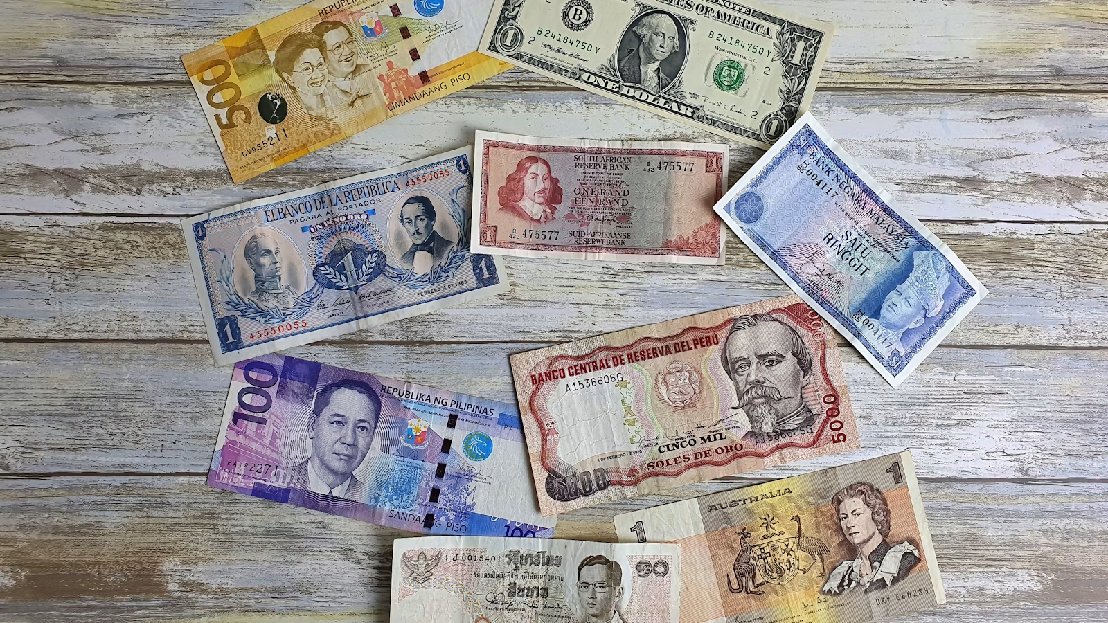 Multiple banknotes showing cross-border FX and currency choice
