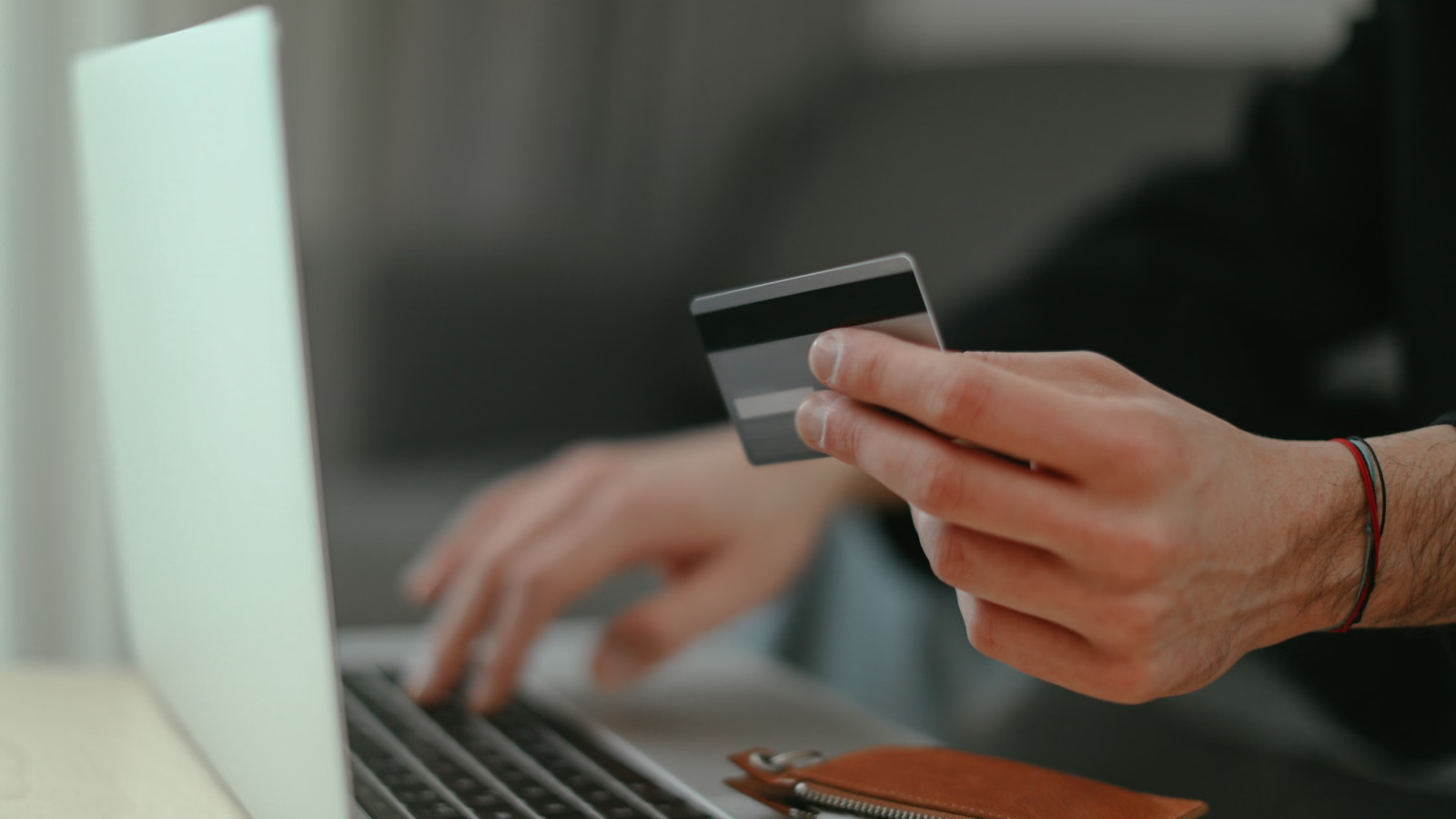 Person using a card while shopping online