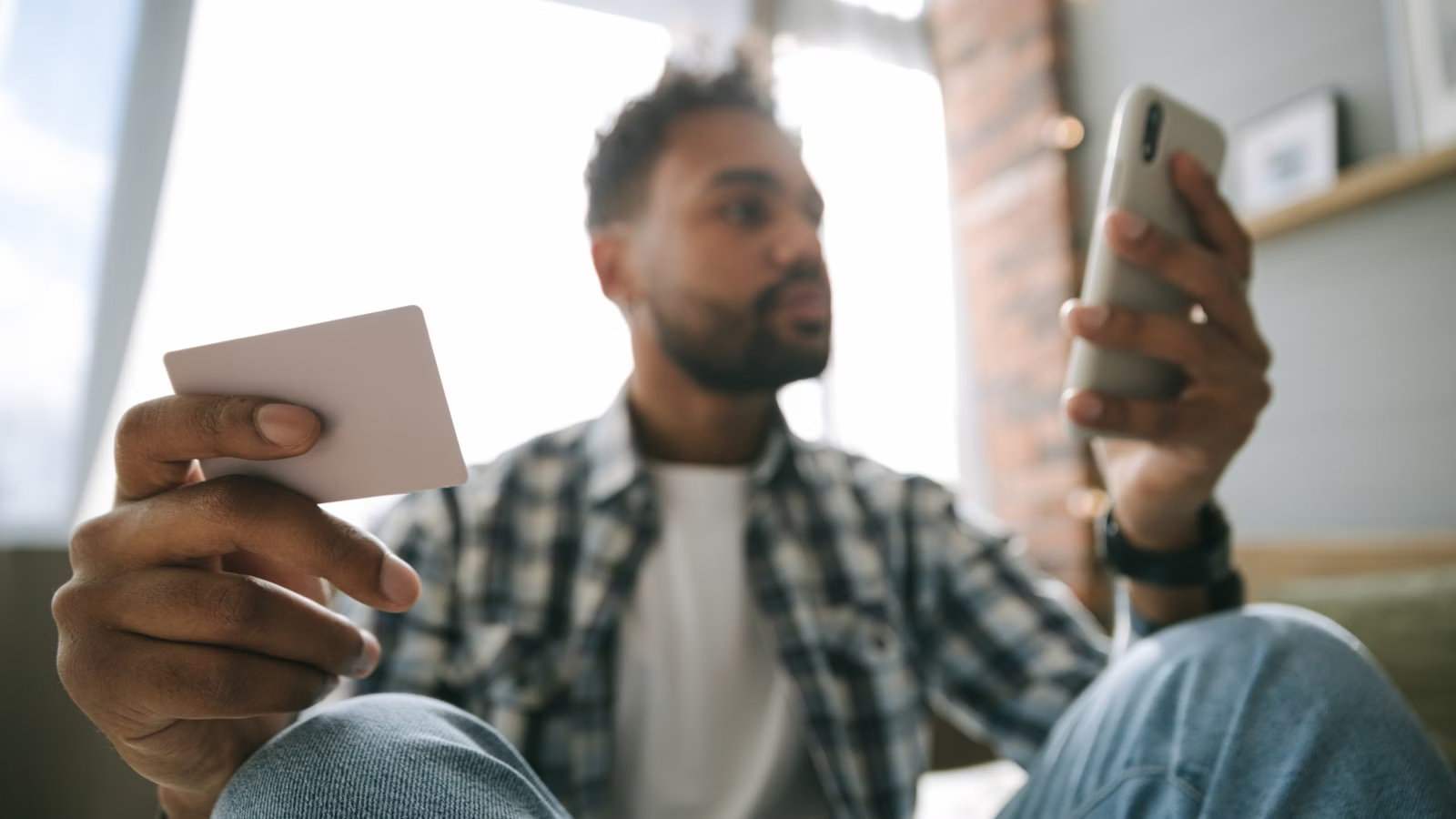 Person using smartphone and card for digital payments