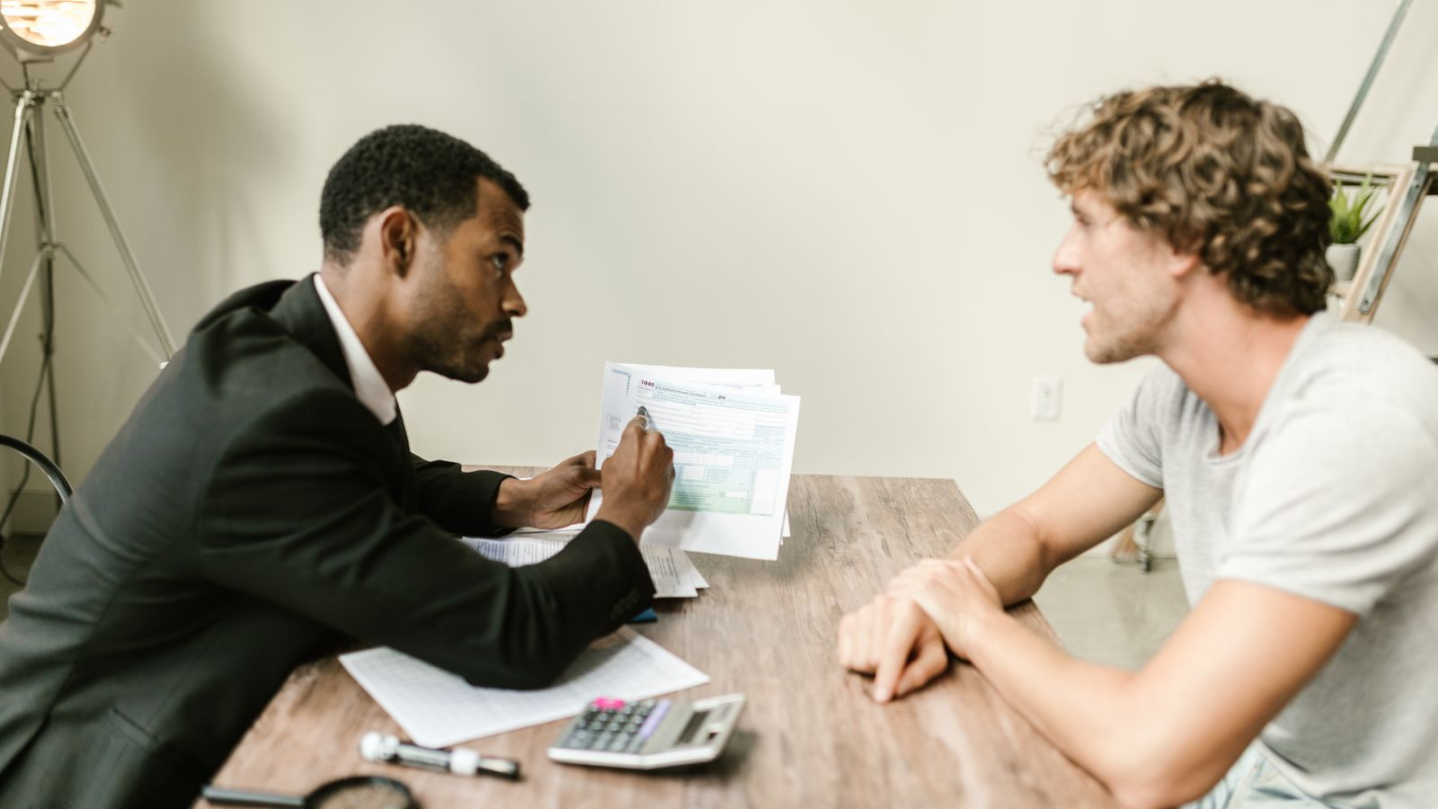 A financial services professional reviewing documents with a client
