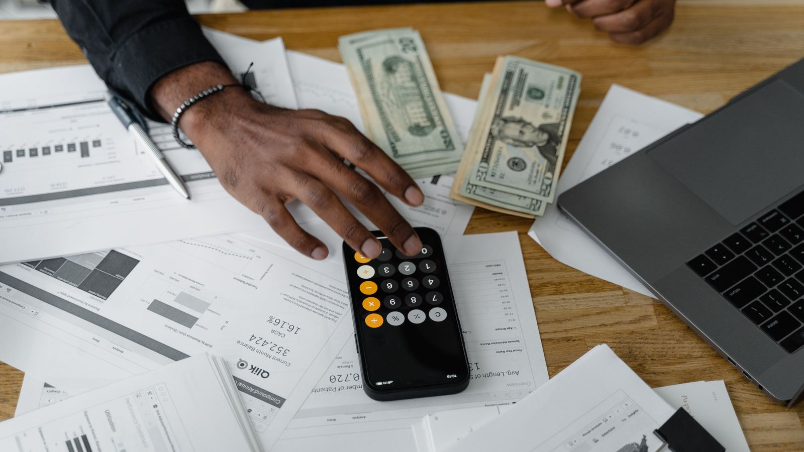 Reviewing financial documents and using a calculator to organize application information