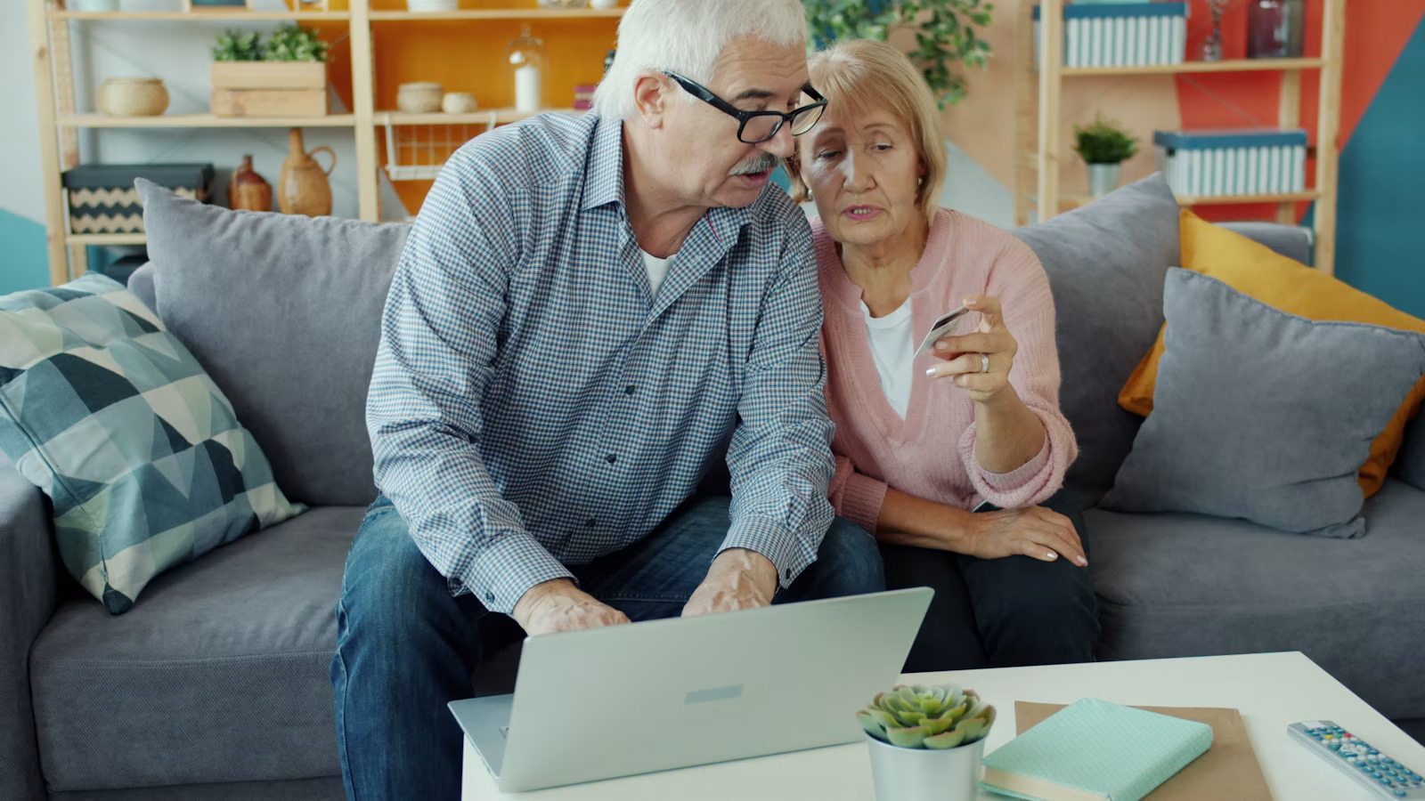 Two people checking an online payment on a laptop