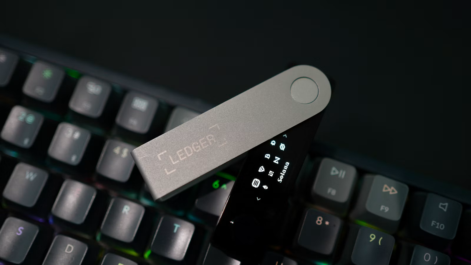A hardware wallet on a computer keyboard illustrating private key management and transaction authorization