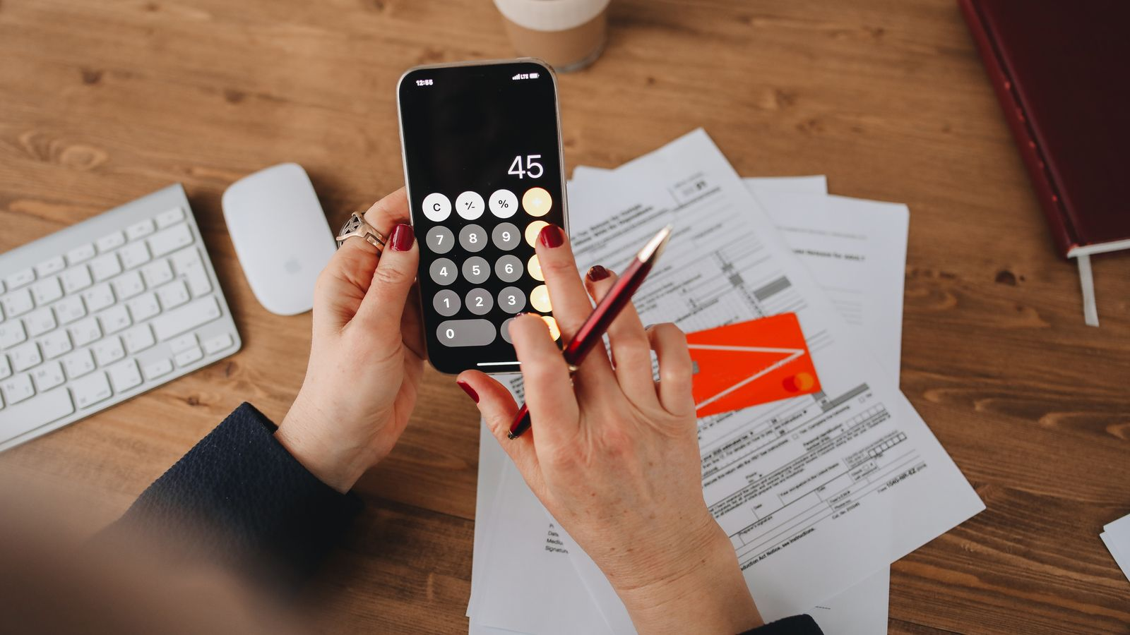 A phone calculator used to check financial documents and amounts