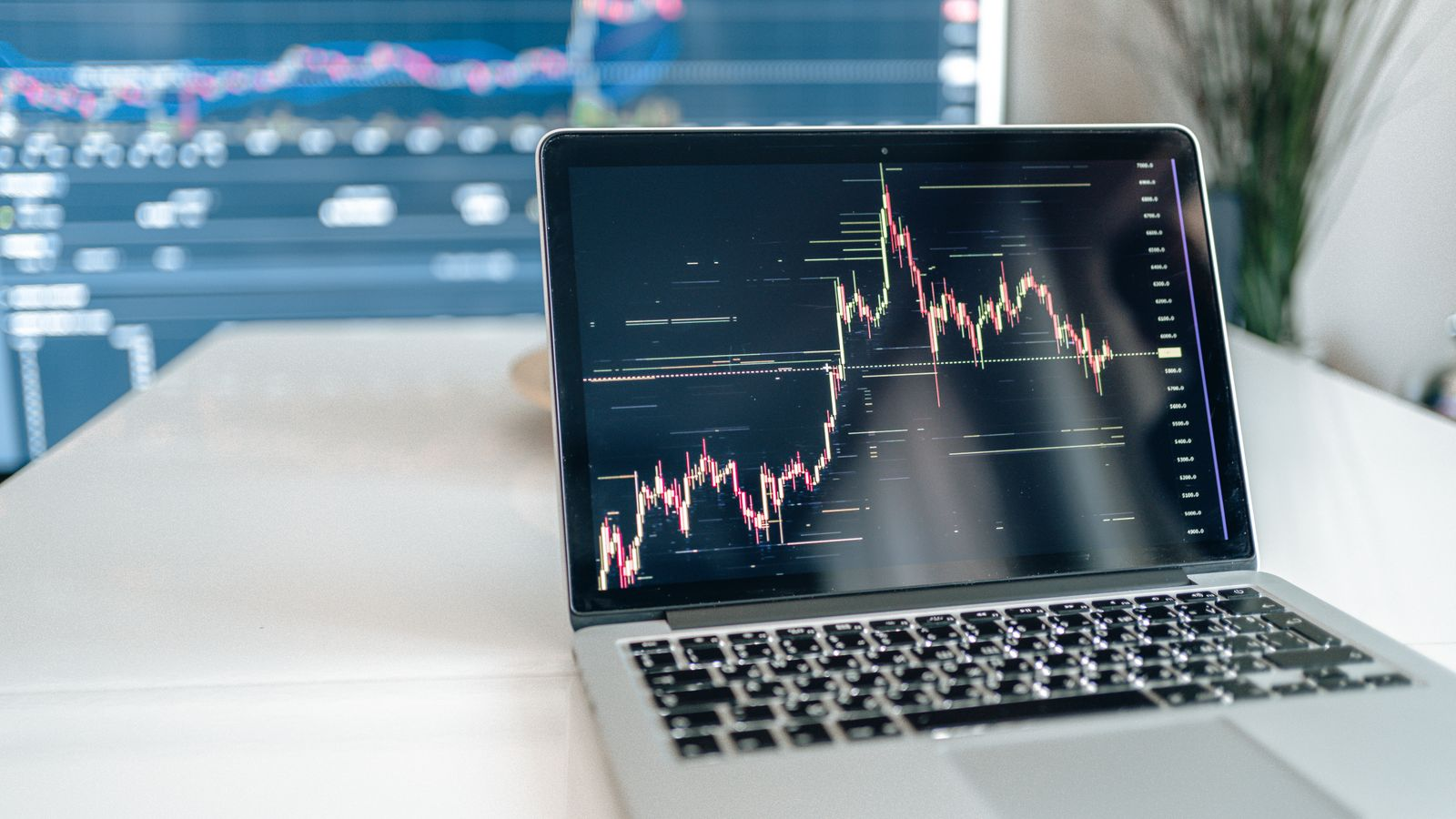 Cryptocurrency price charts on a laptop